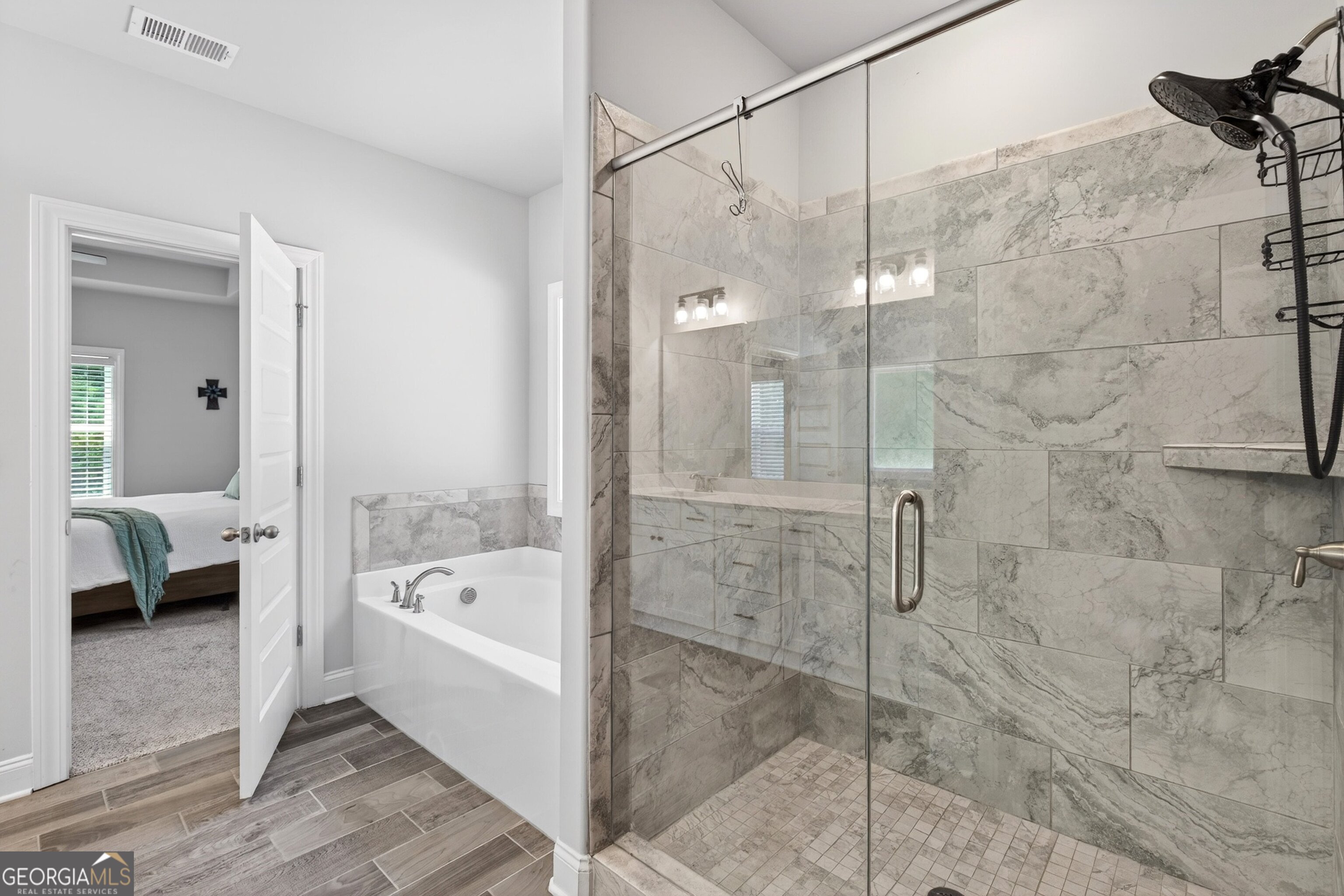 1764 Luther Bailey Road Senoia, GA 30276 - Photo 23 of 63 a bathroom with a bathtub and a shower