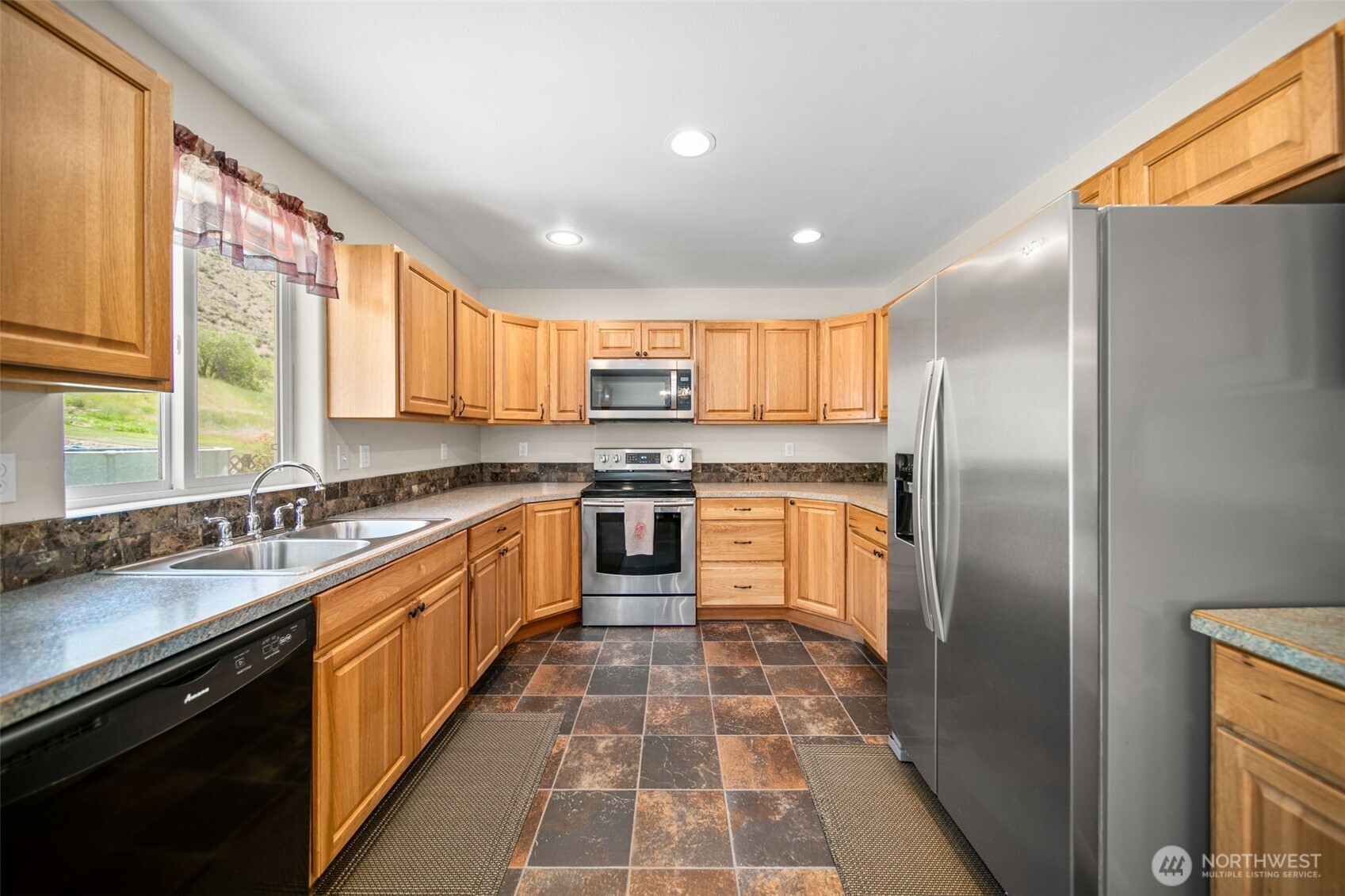 6132 Entiat River Road Entiat, WA 98822 - Photo 14 of 40 a large kitchen with stainless steel appliances granite countertop a stove a sink and a refrigerator