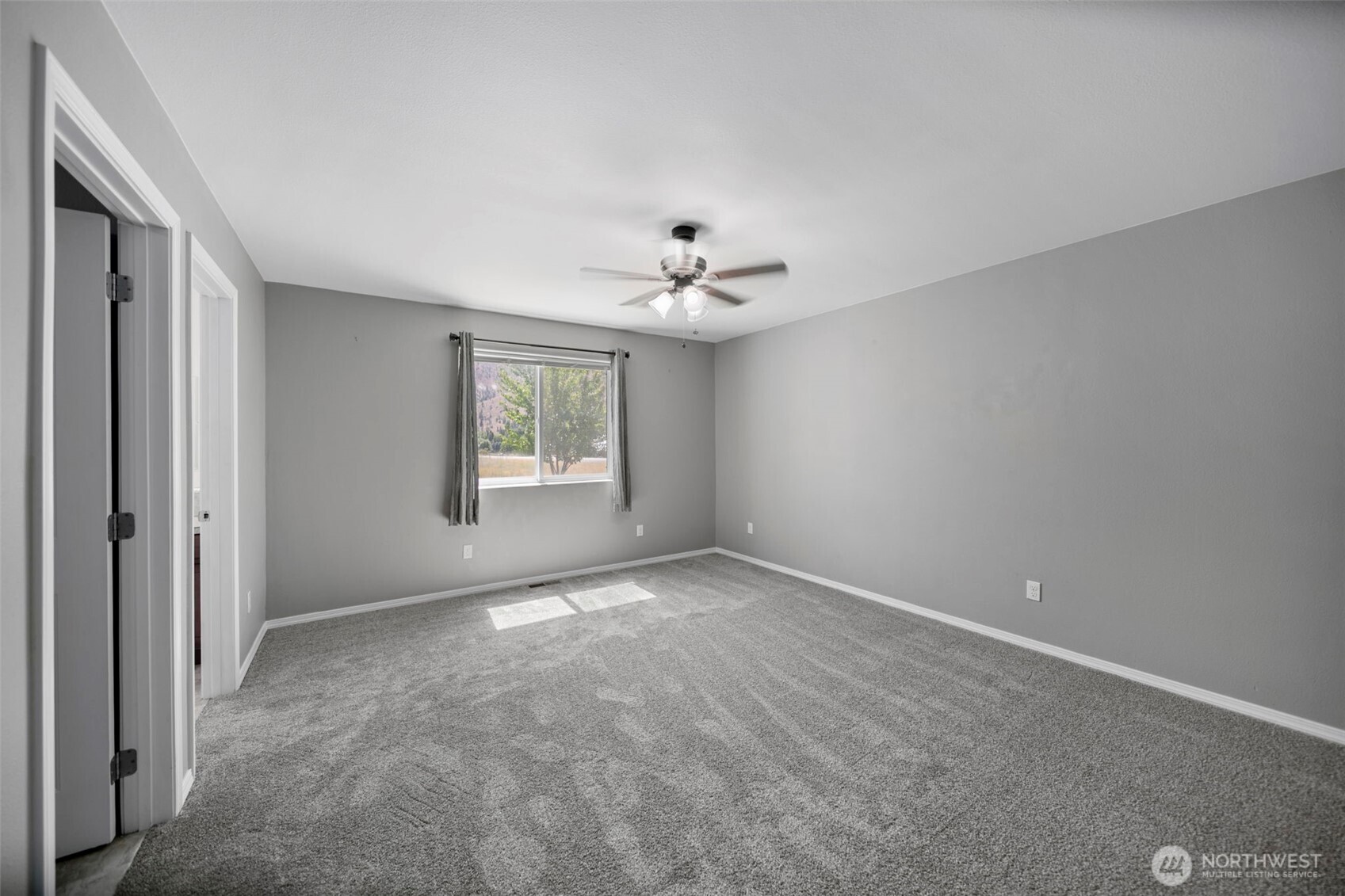 6132 Entiat River Road Entiat, WA 98822 - Photo 19 of 40 a view of a big room with windows and chandelier fan