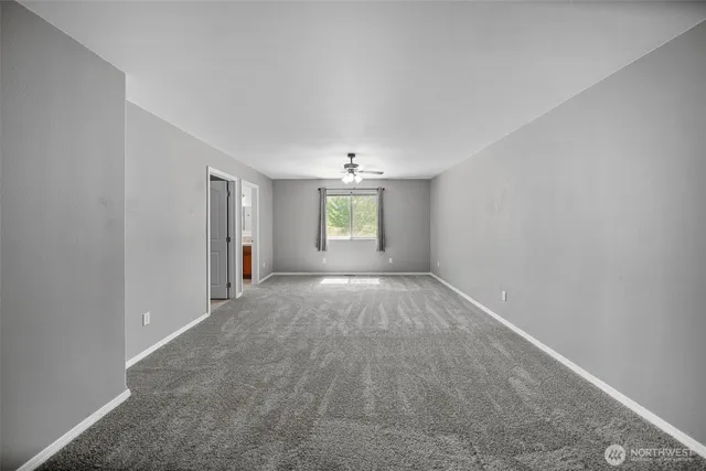 a spacious bathroom with double vanity sink a two mirror a window and a shower