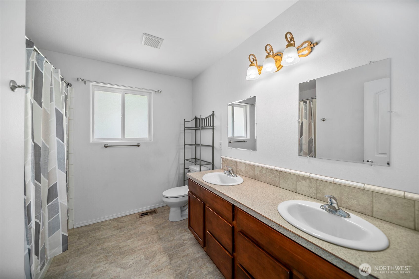 6132 Entiat River Road Entiat, WA 98822 - Photo 21 of 40 a spacious bathroom with double vanity sink a two mirror a window and a shower