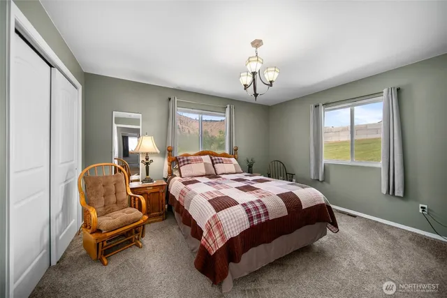 a bedroom with a bed and a chandelier