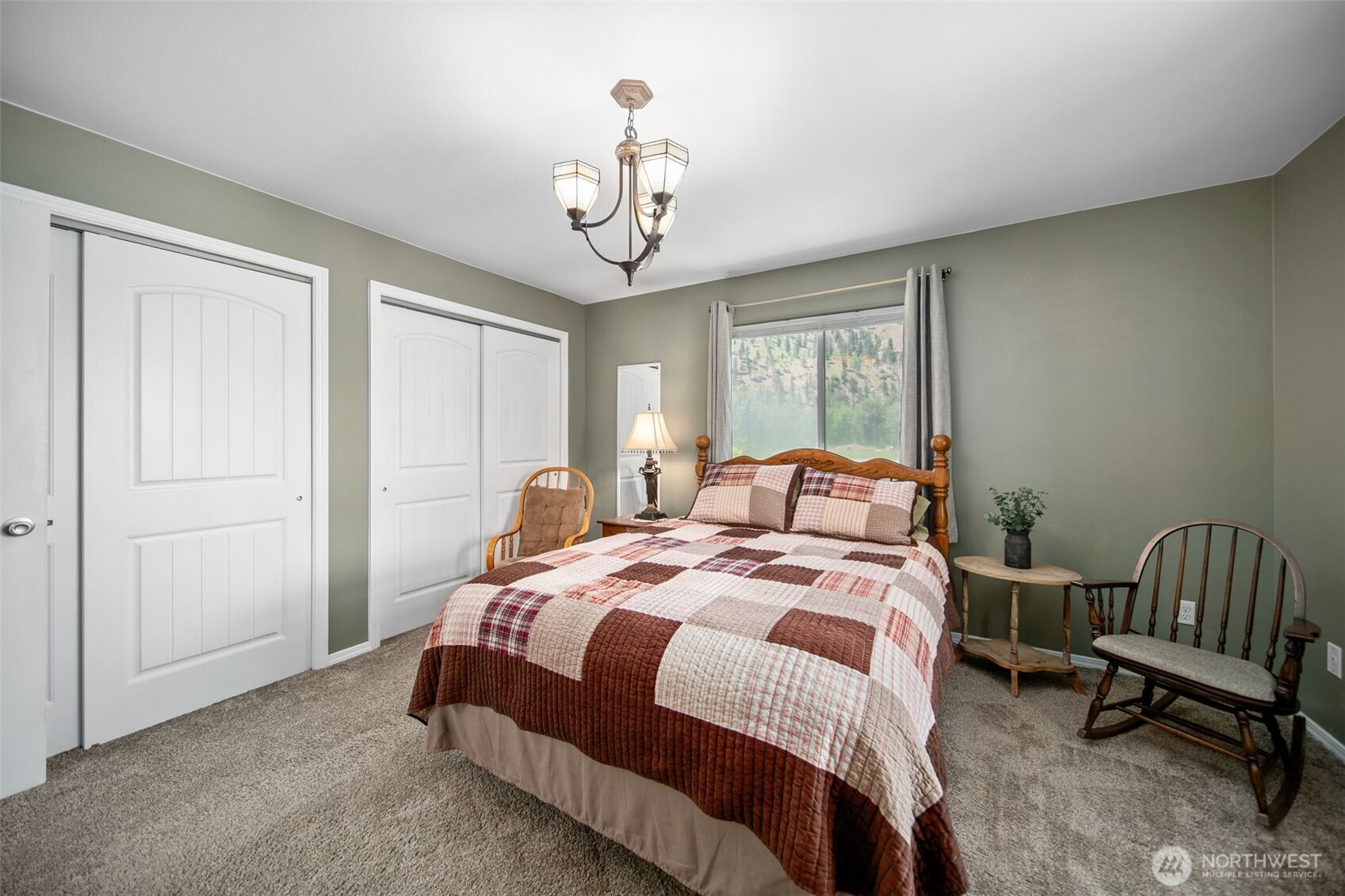 6132 Entiat River Road Entiat, WA 98822 - Photo 29 of 40 a bedroom with a bed and a chandelier