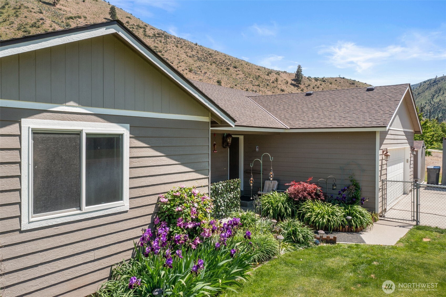 6132 Entiat River Road Entiat, WA 98822 - Photo 3 of 40 a house with a flower garden in front of it