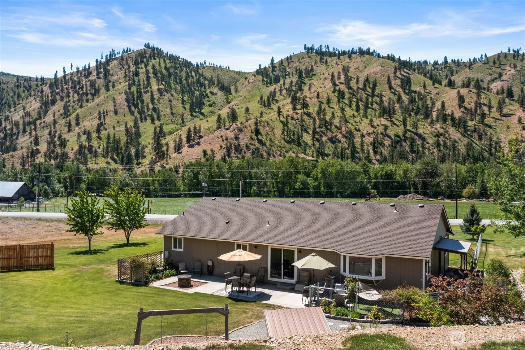 6132 Entiat River Road Entiat, WA 98822 - Photo 32 of 40 an aerial view of a house with garden space and trees in the background