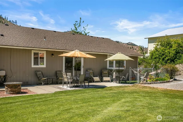 a backyard of a house with table and chairs