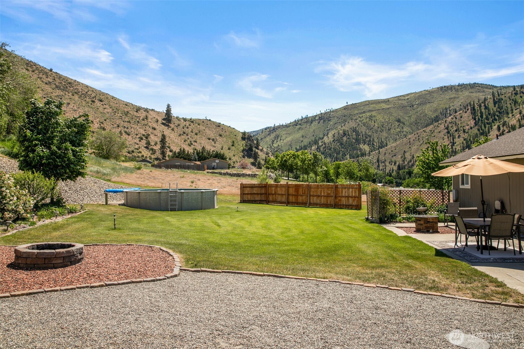 6132 Entiat River Road Entiat, WA 98822 - Photo 39 of 40 a view of a patio with a table and chairs under an umbrella