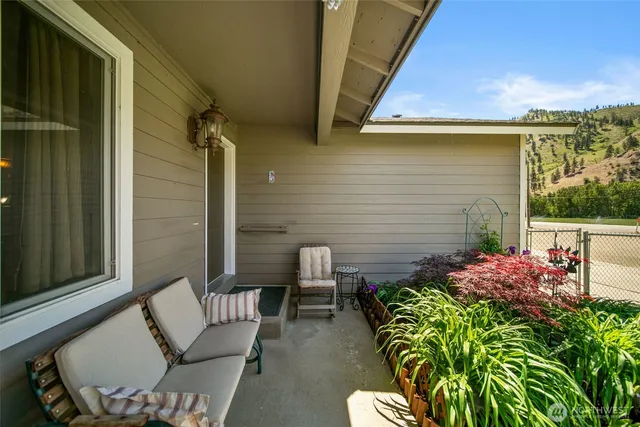 a view of a porch with chairs and a potted plant