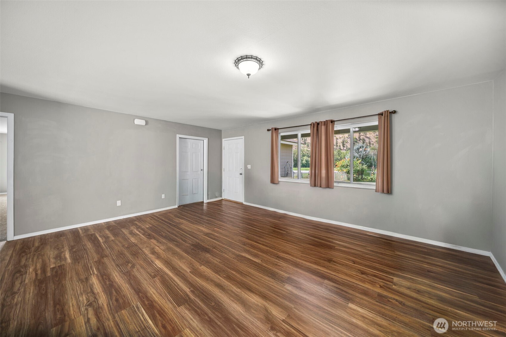 6132 Entiat River Road Entiat, WA 98822 - Photo 8 of 40 a view of an empty room with wooden floor and a window