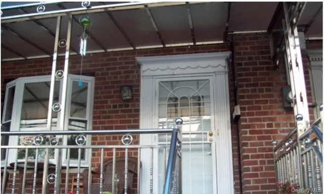 a view of a brick house with a large window