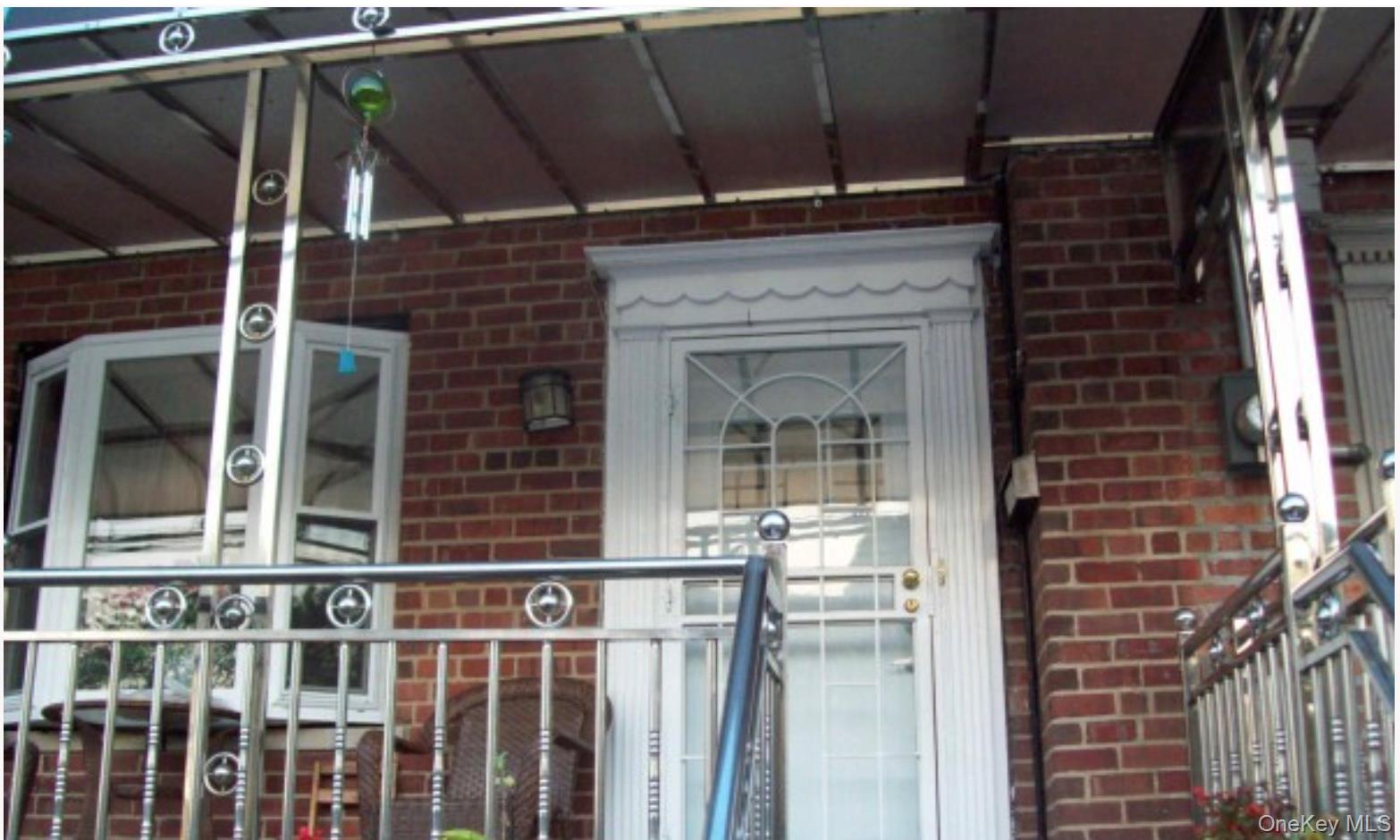 2713 Eastchester Road Bronx, NY 10469 - Photo 2 of 13 a view of a brick house with a large window