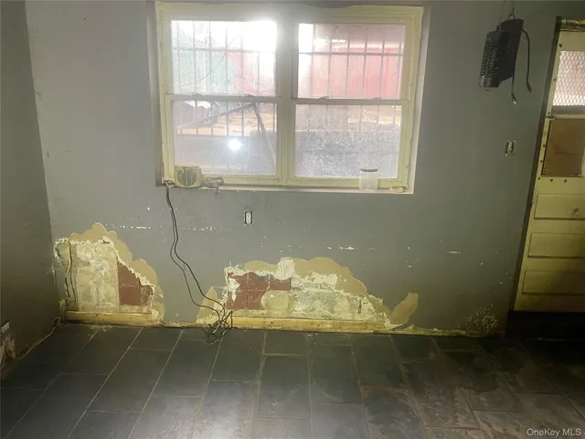 a view of a livingroom with wooden floor and a window