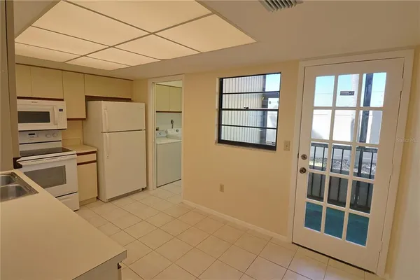 a kitchen with a refrigerator a washer and dryer