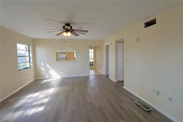 wooden floor in an empty room with a window