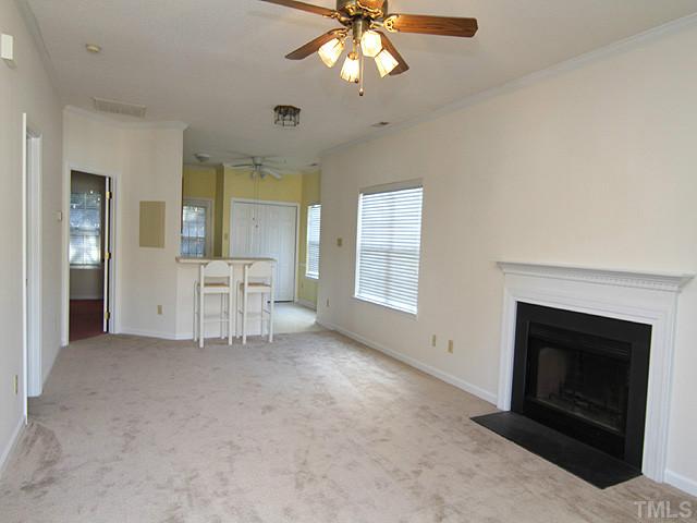 4475 Still Pines Drive Raleigh, NC 27613 - Photo 2 of 12 an empty room with windows and fireplace