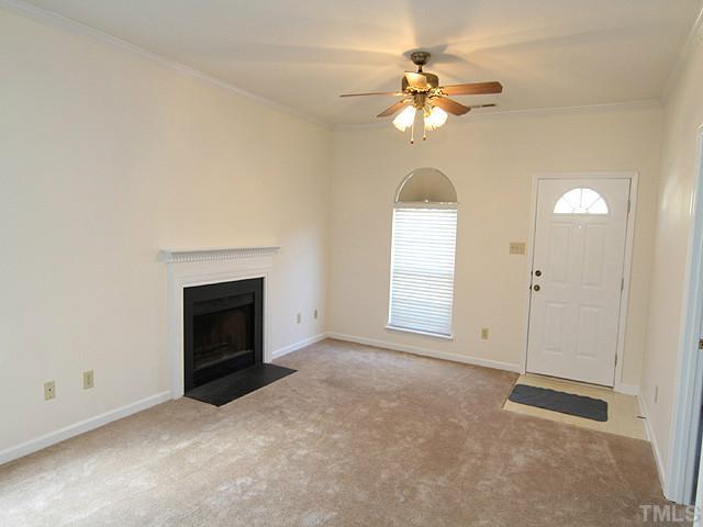 4475 Still Pines Drive Raleigh, NC 27613 - Photo 3 of 12 an empty room with chandelier fan and windows