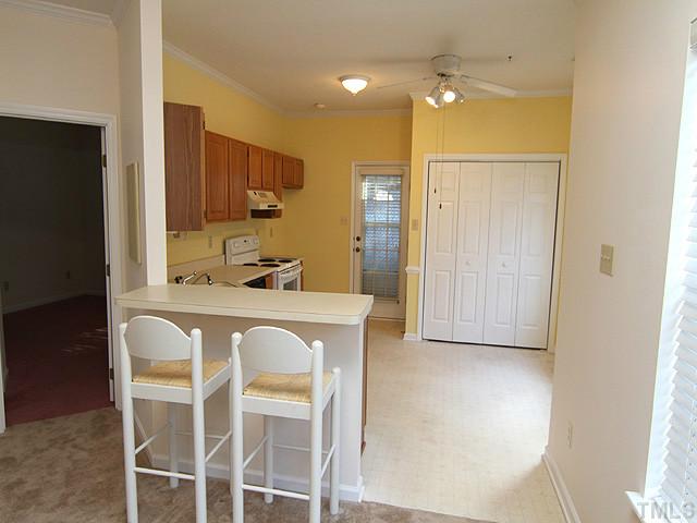 4475 Still Pines Drive Raleigh, NC 27613 - Photo 4 of 12 a living room with white cabinets and chandelier