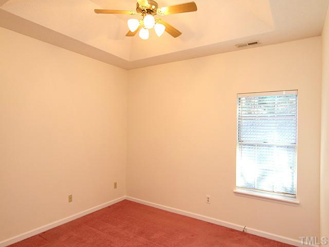 4475 Still Pines Drive Raleigh, NC 27613 - Photo 7 of 12 an empty room with a window and a fan