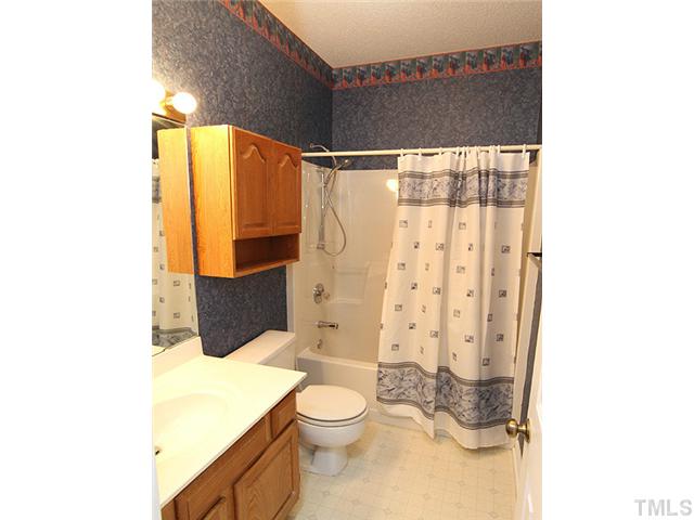 4475 Still Pines Drive Raleigh, NC 27613 - Photo 10 of 12 a bathroom with a granite countertop sink toilet and shower