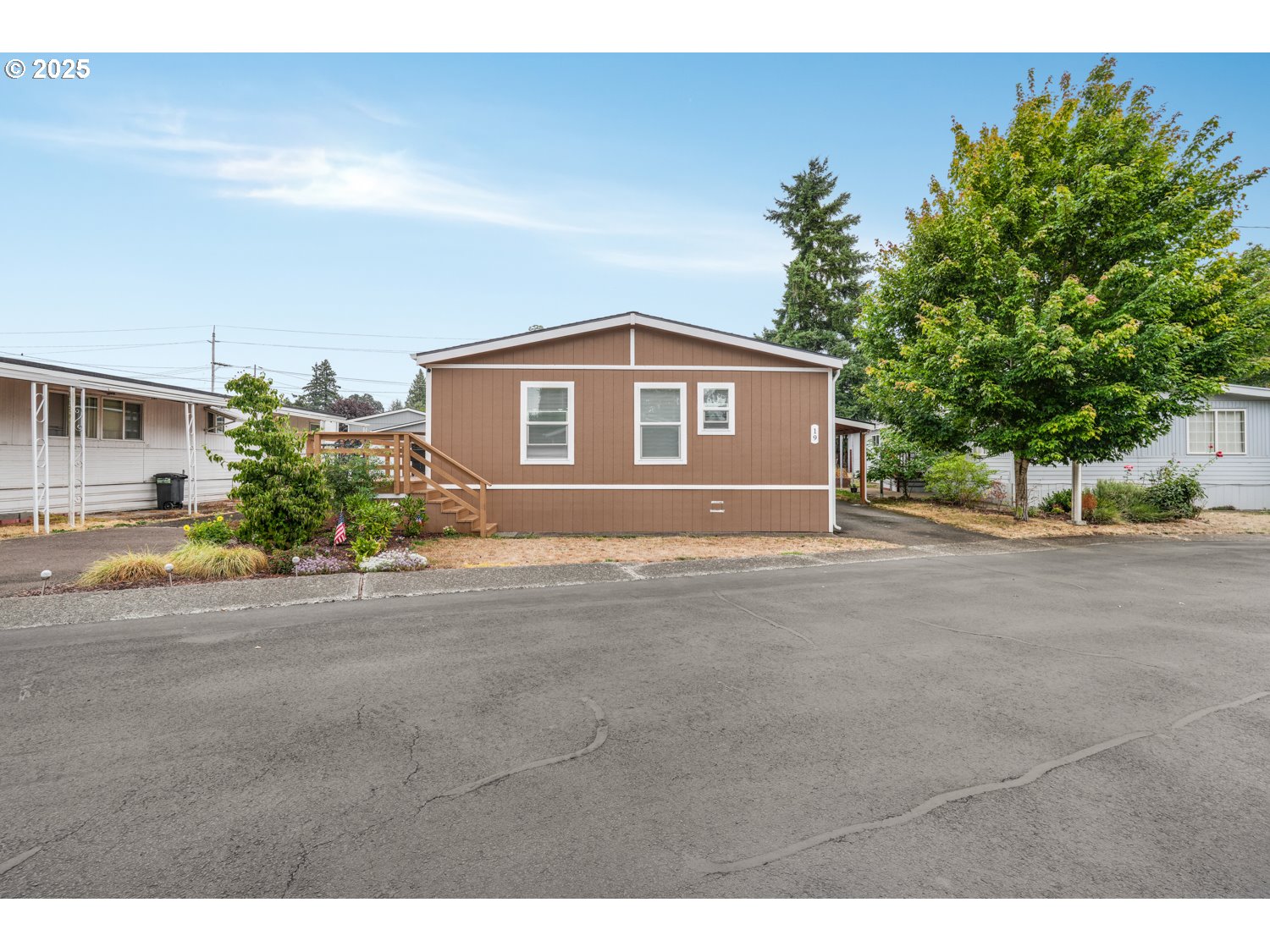 18780 South Central Point Road, Unit 19 Oregon City, OR 97045 - Photo 15 of 25 a front view of a house with a yard and garage