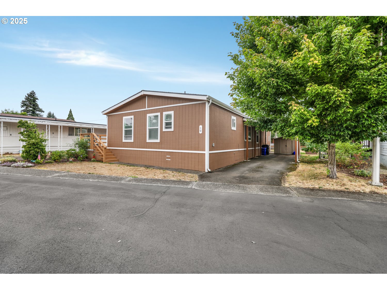 18780 South Central Point Road, Unit 19 Oregon City, OR 97045 - Photo 16 of 25 a view of a house with a yard and garage