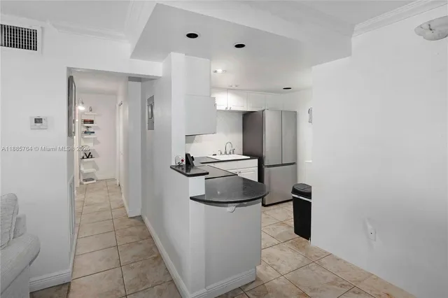 a kitchen with a stove a refrigerator and a sink