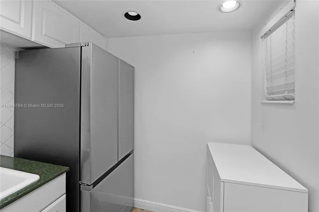 a kitchen with a stove and white cabinets