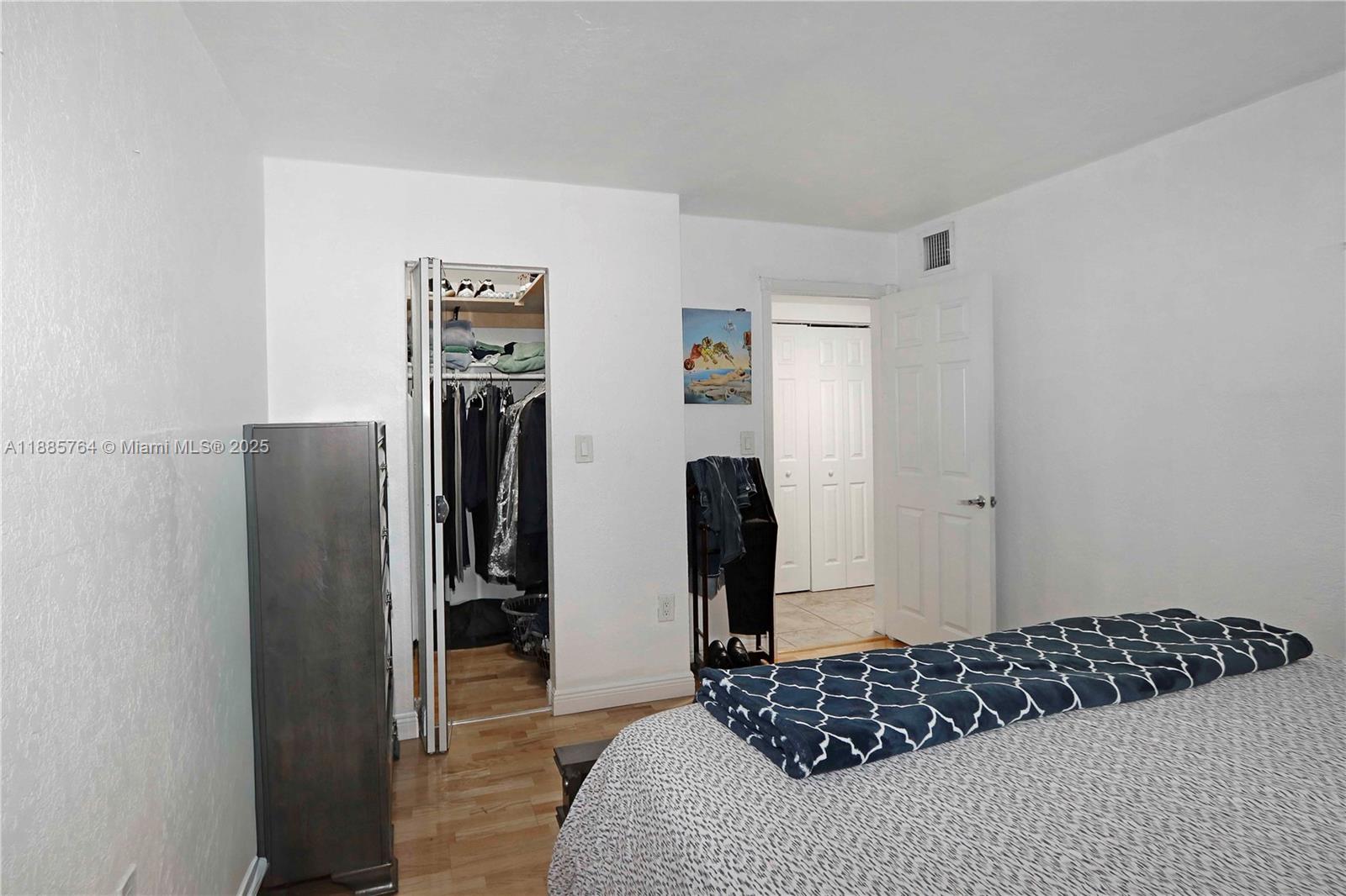 8617 Southwest 68th Court, Unit 24 Pinecrest, FL 33156 - Photo 18 of 24 a bedroom with a bed and a window