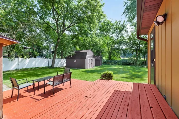 a view of backyard with wooden floor and outdoor seating