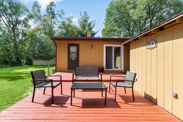 a view of a house with backyard and sitting area