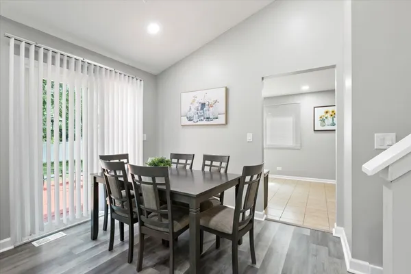 a view of a dining room with furniture and wooden floor
