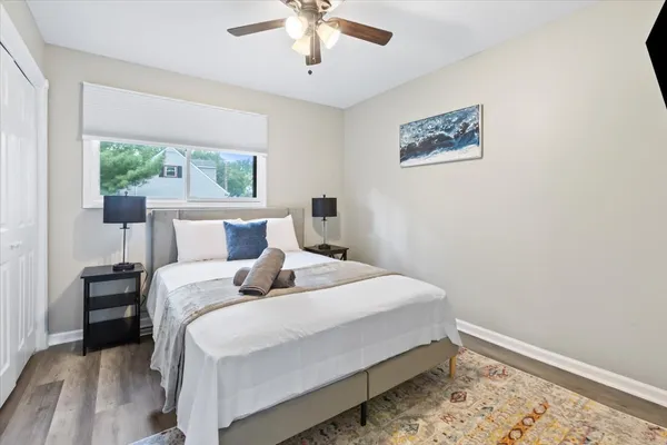 a bedroom with a bed and a window