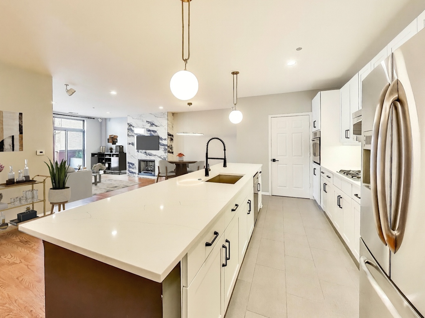 33 West Huron Street, Unit 412 Chicago, IL 60654 - Photo 14 of 33 a large kitchen with stainless steel appliances a stove a sink a refrigerator and a dining table with wooden floor