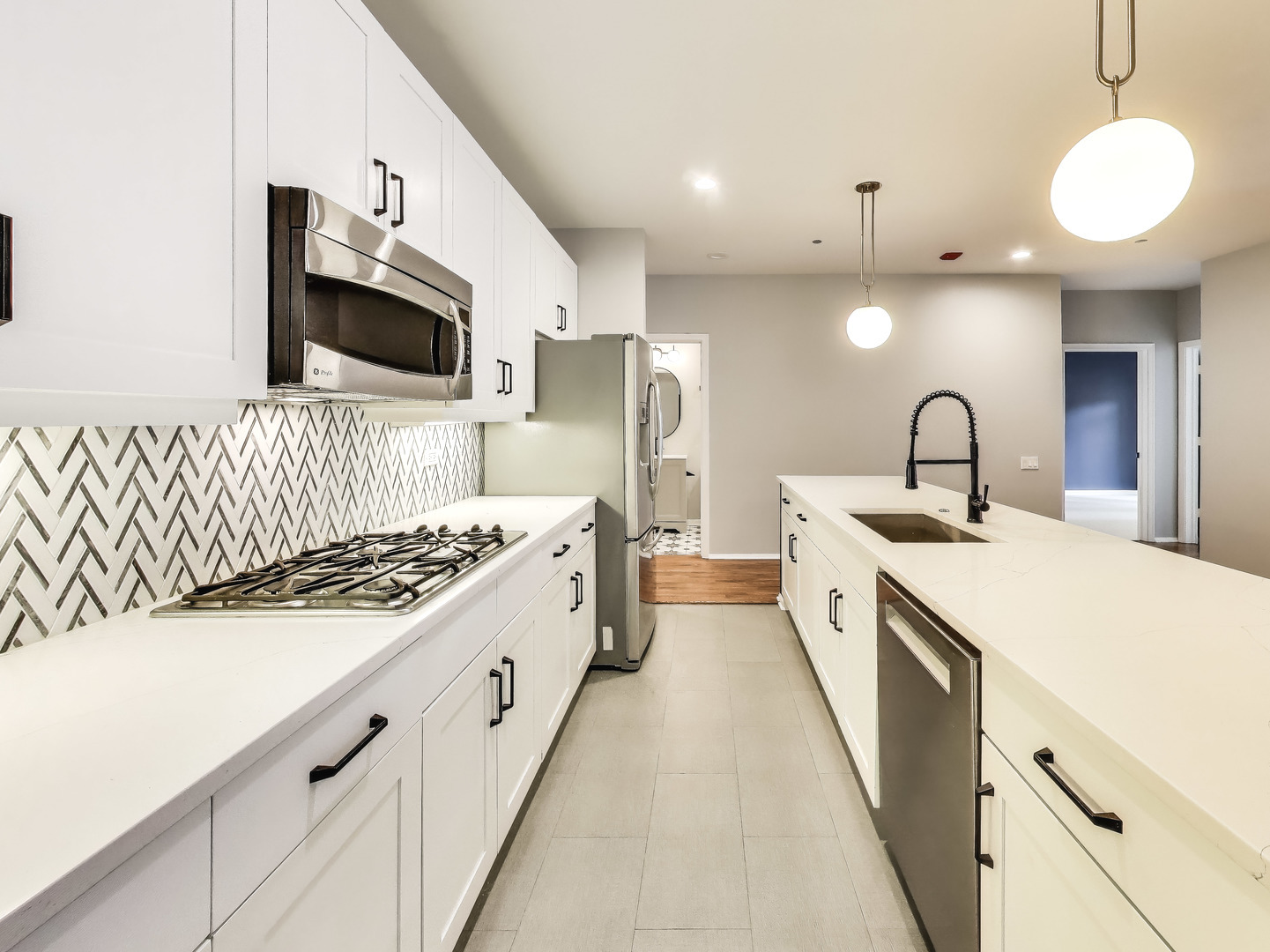 33 West Huron Street, Unit 412 Chicago, IL 60654 - Photo 17 of 33 a kitchen with a sink stove and microwave