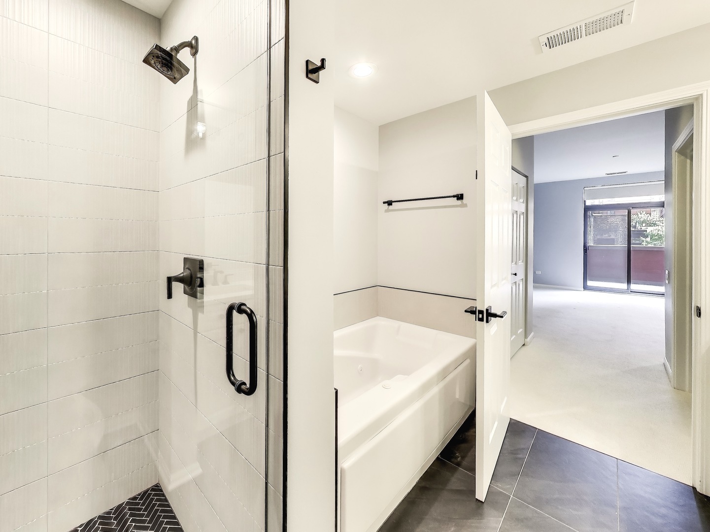 33 West Huron Street, Unit 412 Chicago, IL 60654 - Photo 25 of 33 a bathroom with a tub and a shower