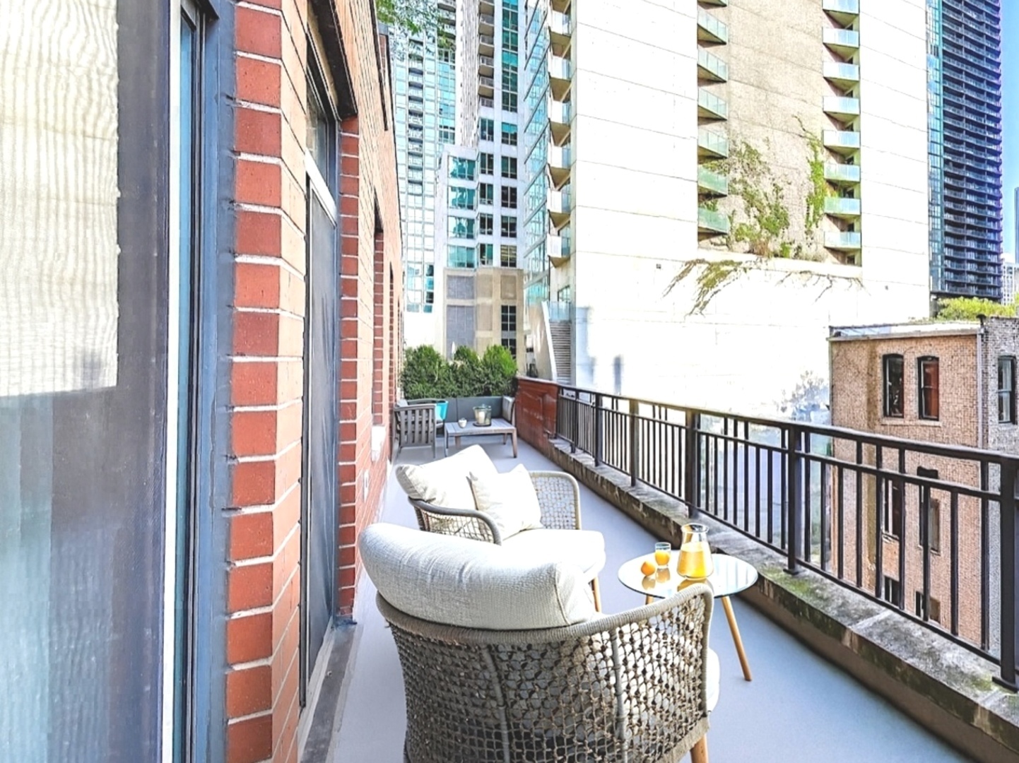 33 West Huron Street, Unit 412 Chicago, IL 60654 - Photo 32 of 33 a balcony with furniture and a window