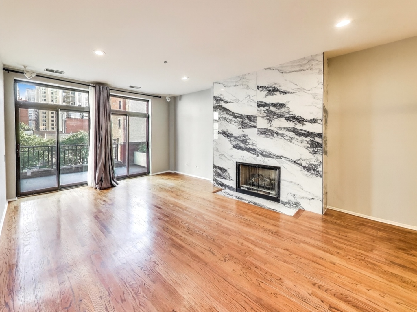 33 West Huron Street, Unit 412 Chicago, IL 60654 - Photo 7 of 33 a view of a livingroom with wooden floor and a fireplace