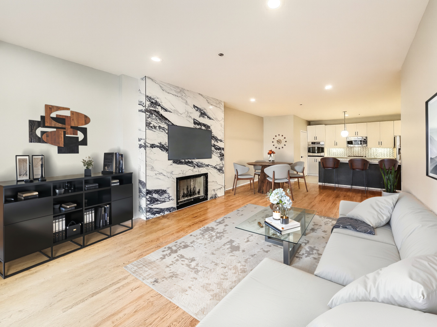 33 West Huron Street, Unit 412 Chicago, IL 60654 - Photo 10 of 33 a living room with furniture and a flat screen tv with kitchen view