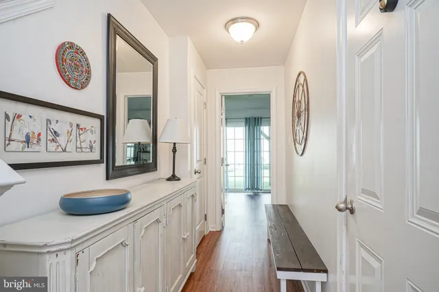 a view of a hallway with wooden floor and workspace