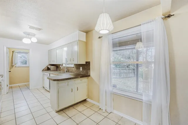 a kitchen with stainless steel appliances granite countertop a sink and cabinets