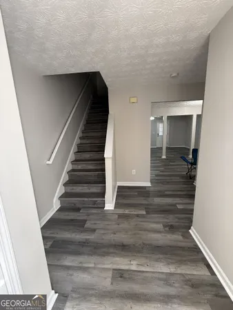 a view of entryway and hall with wooden floor