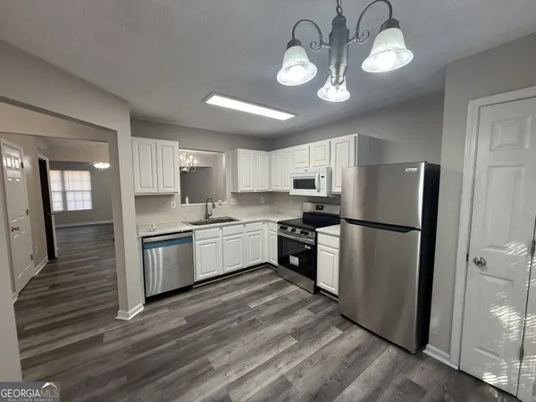 a kitchen with a refrigerator a sink and dishwasher