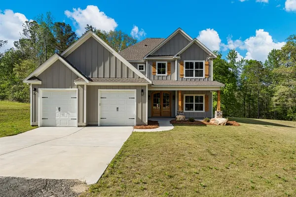 a front view of a house with a yard and garage