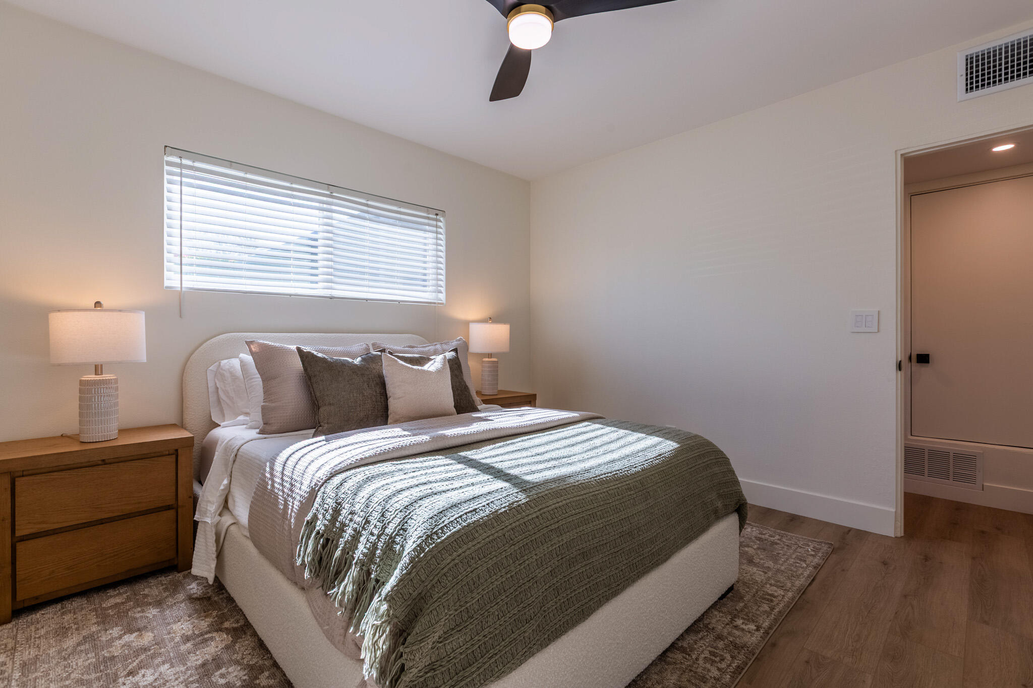 41615 Morningside Court, Unit A Rancho Mirage, CA 92270 - Photo 14 of 20 a bedroom with a bed and wooden floor