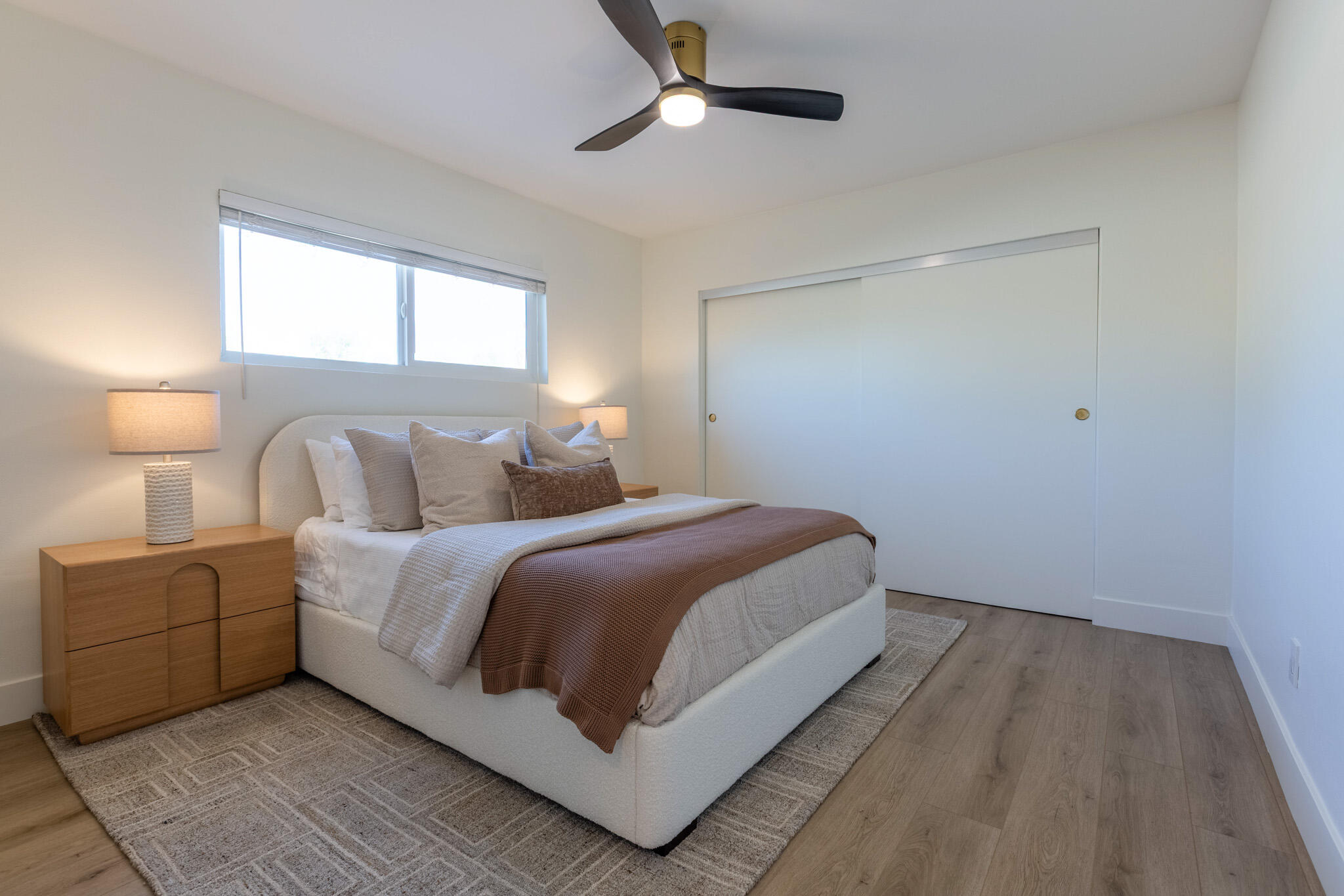 41615 Morningside Court, Unit A Rancho Mirage, CA 92270 - Photo 15 of 20 a bedroom with a bed lamp on dresser and a window