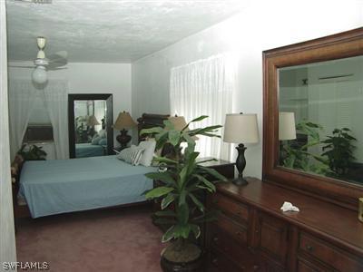 18612 Geranium Road Fort Myers, FL 33967 - Photo 3 of 9 a living room with furniture flowerpot and wooden floor
