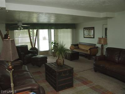 18612 Geranium Road Fort Myers, FL 33967 - Photo 4 of 9 a living room with furniture a window and a potted plant