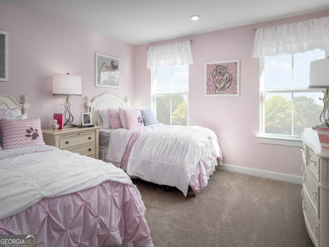 a bedroom with two beds and a window