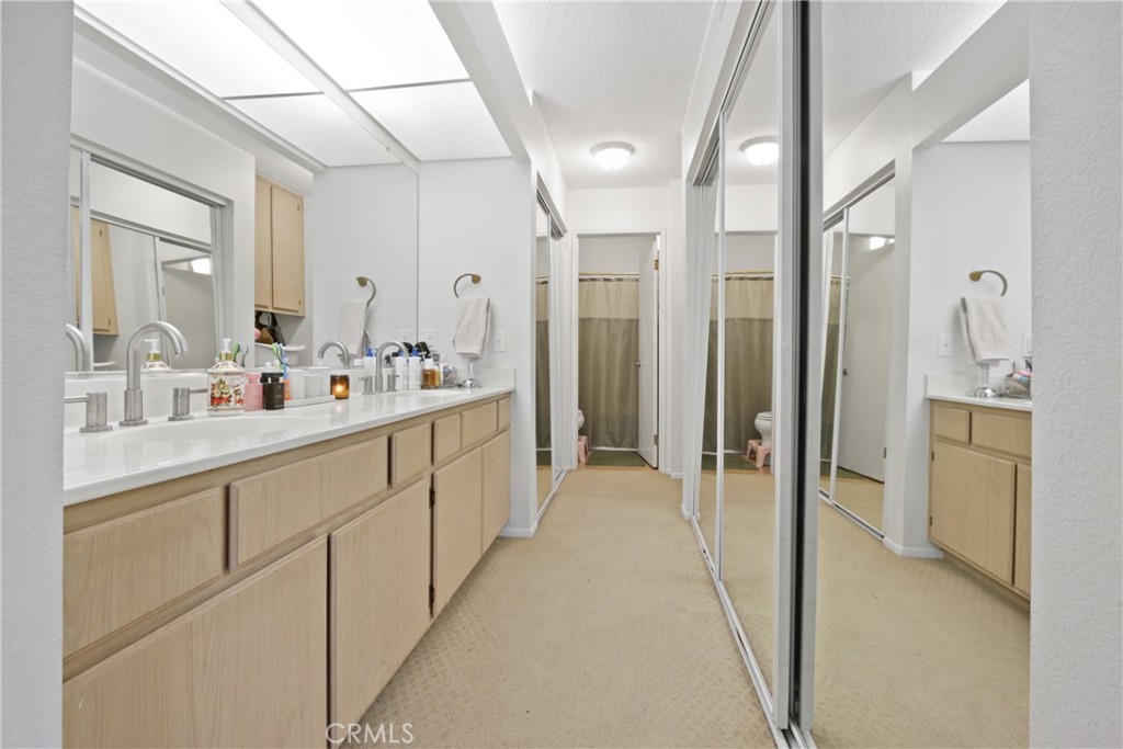 112 Timbre Rancho Santa Margarita, CA 92688 - Photo 8 of 11 a bathroom with a double vanity sink mirror and shower