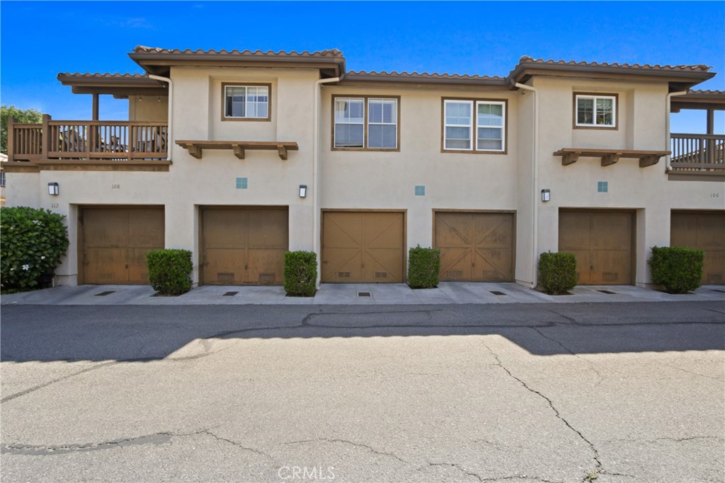 112 Timbre Rancho Santa Margarita, CA 92688 - Photo 10 of 11 a front view of a house with a yard and a garage